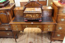 Shoolbred inlaid mahogany writing desk having mirror back flanked by four drawers,