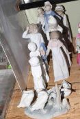 Eleven figurines including Lladro, Nao and Spode.