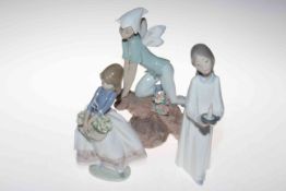 Three Lladro figures.