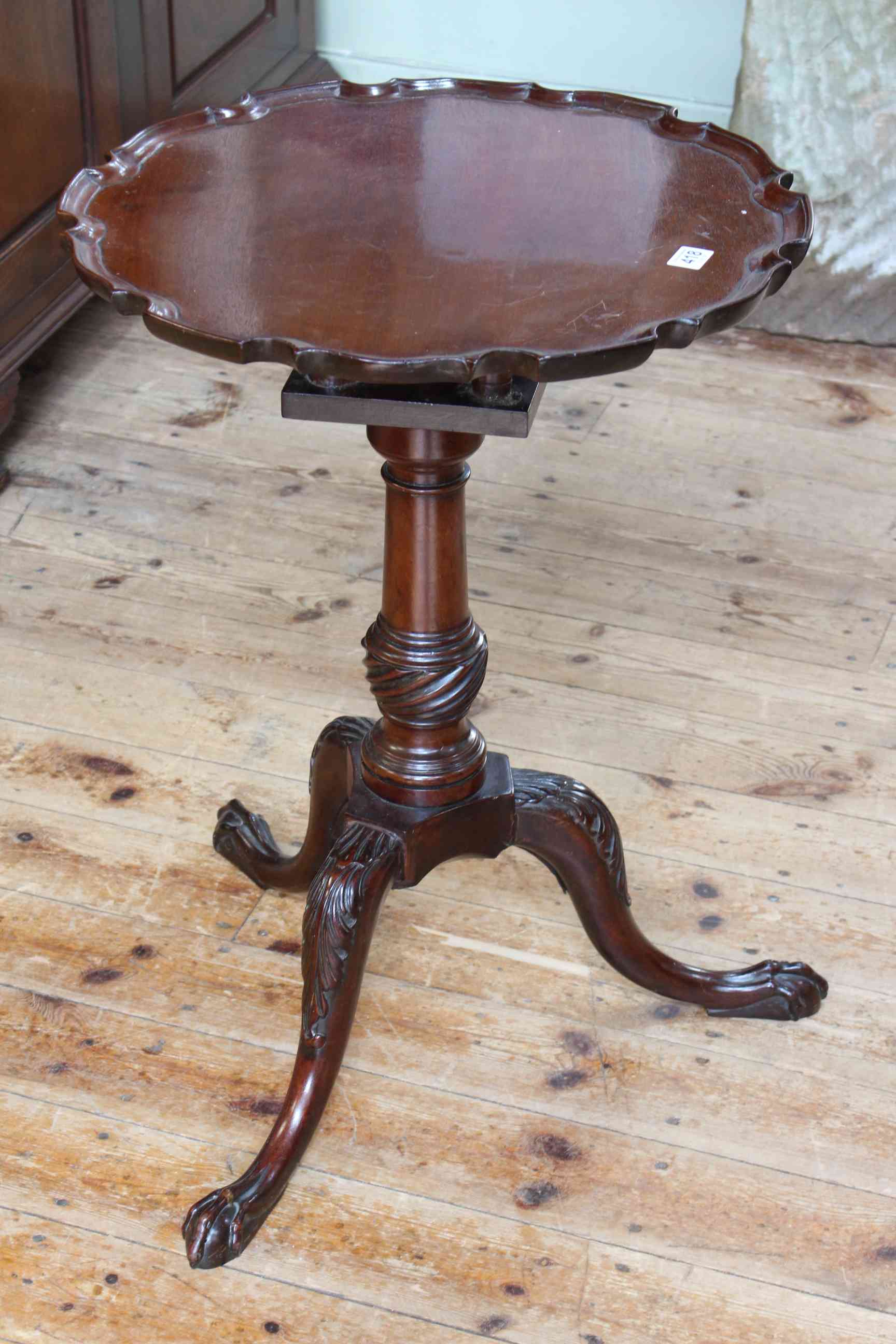 Mahogany circular dished top occasional table in triform base, 69cm by 50cm diameter.