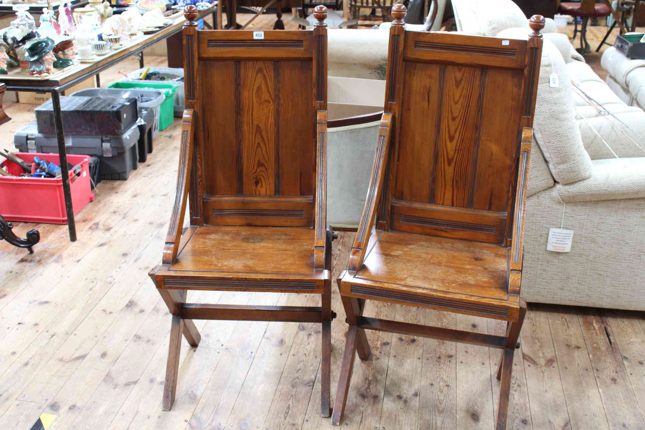 Pair 19th Century pitch pine Glastonbury style chapel chairs.