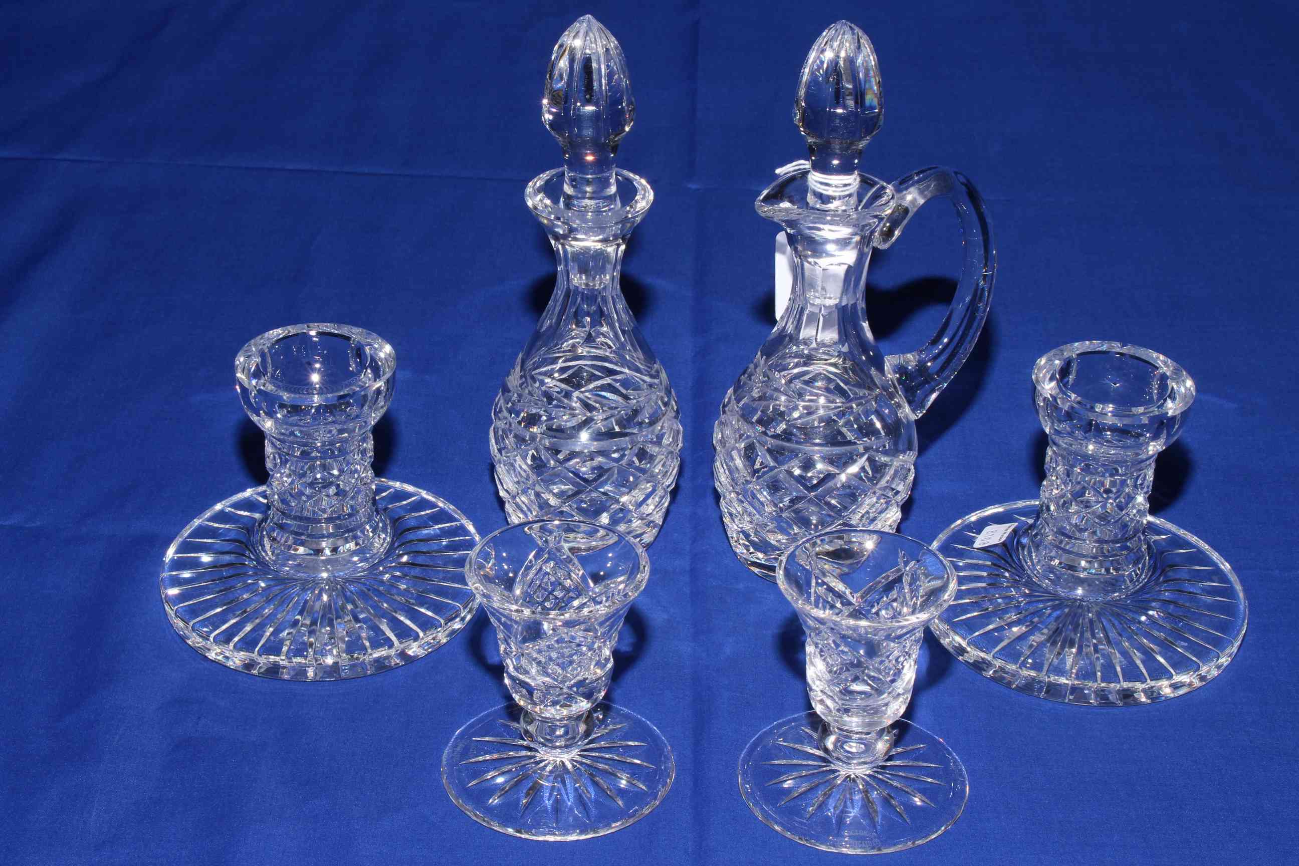 Waterford Crystal vinegar and condiment bottles, two pairs of dwarf candlesticks.