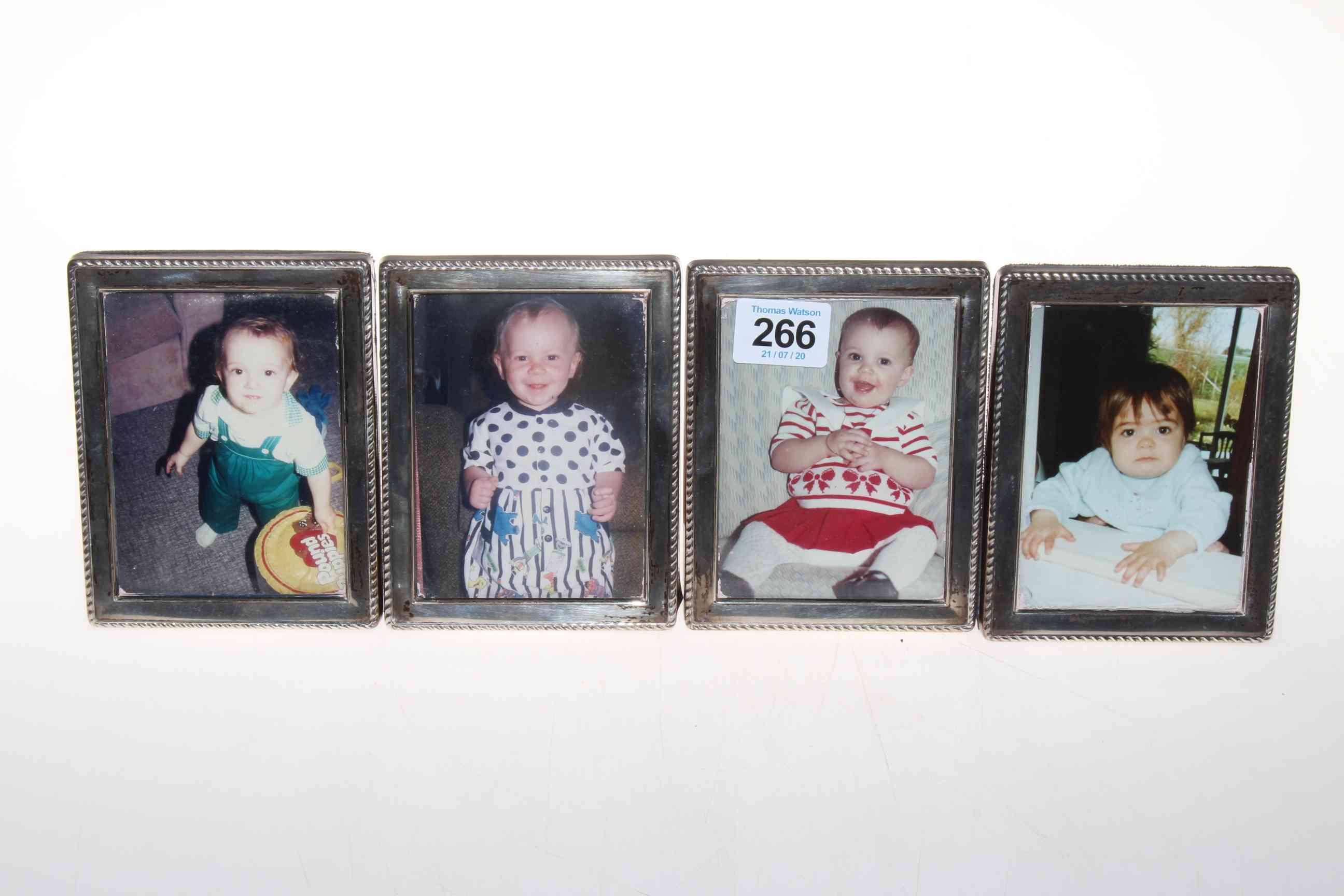 Set of four small silver photograph frames.