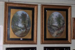 Pair oval oil paintings of Figures in Landscape, in gilt glazed frames, 76cm by 63cm overall.