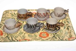 Set of six 'animal' styled cups and saucers.