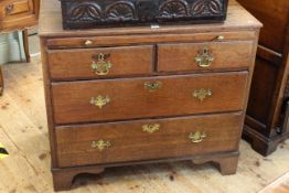 Georgian oak chest having pull out writing surface above two short and two long drawers on bracket