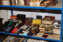 Shelf of collectables, spectacles, pictures, binoculars, camera, children's books, etc.