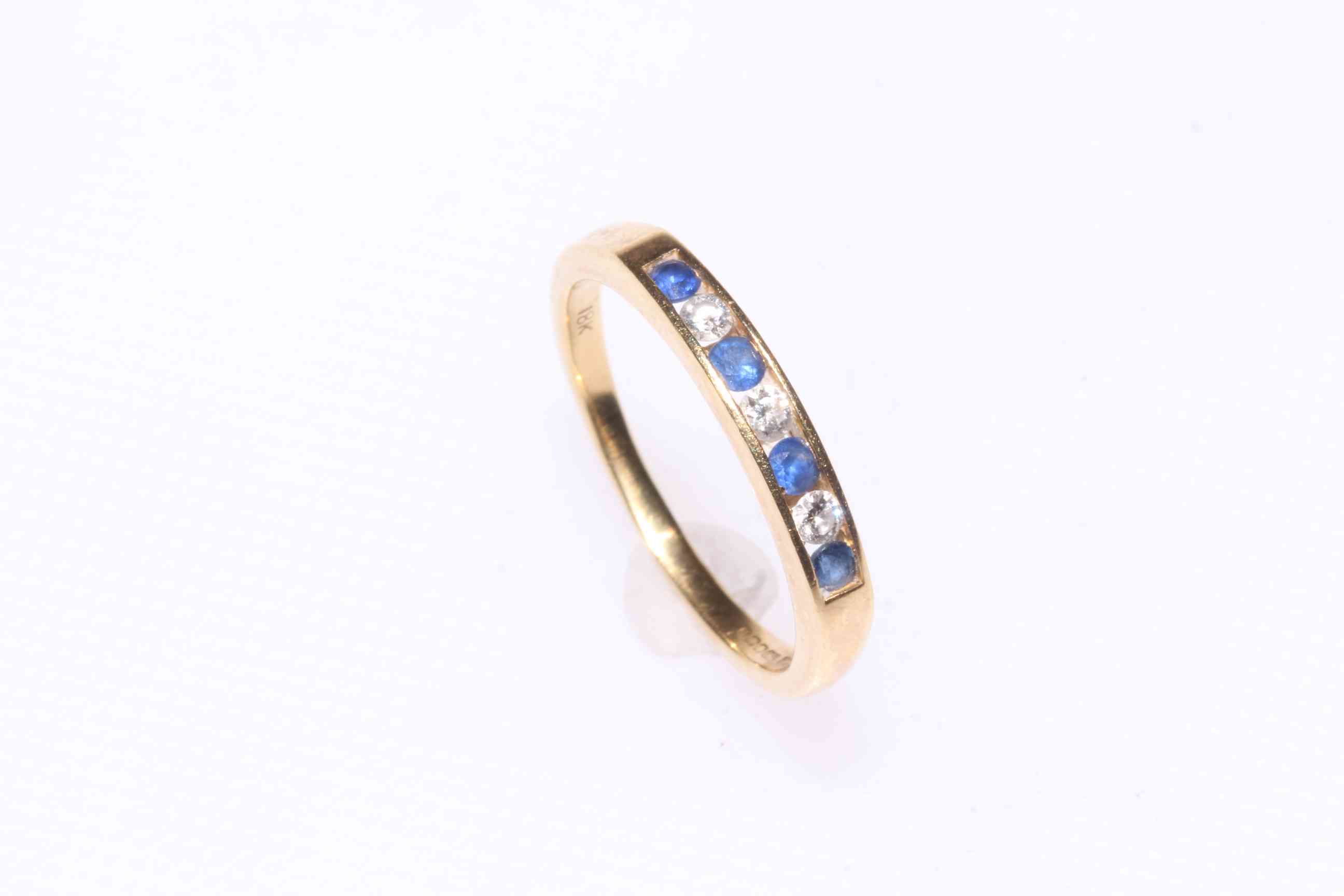18 carat gold, sapphire and diamond seven stone ring.