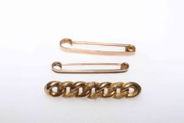 9 carat gold Suffragette brooch and two safety pin brooches.