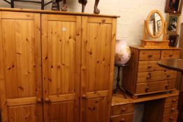 Pine four piece bedroom suite comprising triple door wardrobe, pedestal dressing table,