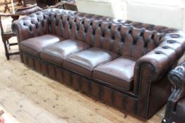 Brown buttoned leather four seater Chesterfield settee, 230cm long by 77cm depth.