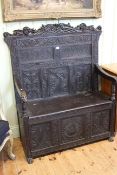 Victorian carved dark oak box settle, 135cm by 106cm.
