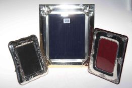 Collection of three silver mounted easel photograph frames, largest with bevelled glass,