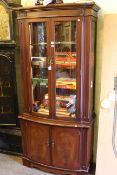 Strongbow mahogany illuminated four door shaped front display cabinet.