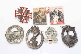 Collection of German military badges and miniature volumes.
