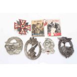 Collection of German military badges and miniature volumes.