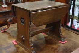 Small oak drop leaf table, the end supports having cut out rose carving and twist pillars,