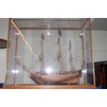 Glass cased wooden galleon, 95cm by 84cm by 36cm.