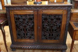 19th Century Continental carved rosewood bookcase having two vine carved fretwork doors enclosing
