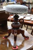 Victorian revolving piano stool on carved tripod base.