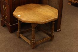 Octagonal oak coffee table on turned legs, 62cm by 47cm.