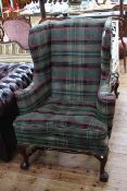 Georgian style wing armchair on ball and claw feet in tartan fabric.