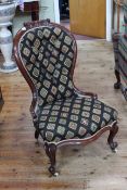 Two similar Victorian mahogany framed nursing chairs in matching fabric.