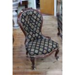 Two similar Victorian mahogany framed nursing chairs in matching fabric.