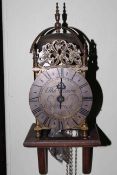 Reproduction brass lantern clock with wall bracket.