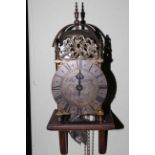 Reproduction brass lantern clock with wall bracket.