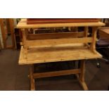 Rectangular stripped pine kitchen table and two benches.