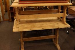 Rectangular stripped pine kitchen table and two benches.