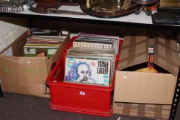 Four boxes of LP records including singles.