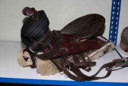 Brown leather and studded saddle, made by the folk people of Tajikistan.