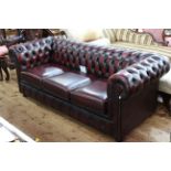 Ox blood deep buttoned leather three seater Chesterfield settee, 193cm by 85cm.