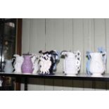 Good collection of ten Victorian stoneware and Parian relief moulded jugs, including Charles Meigh,