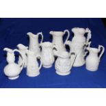 Ten Victorian Parian relief moulded jugs including Prince Consort, Alcock classical figures,