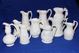 Ten Victorian Parian relief moulded jugs including Prince Consort, Alcock classical figures,