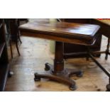 Victorian rosewood fold top card table on turned pedestal to quadriform base, 92cm by 74.