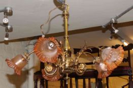 Ornate brass five branch chandelier with etched amber tinted shades.