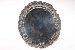George IV silver salver, engraved with foliage and having ornate border, on paw feet,