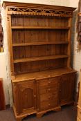 Pine dresser, the shelf back above a breakfront base of four drawers and two carved panel doors,