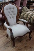 Victorian mahogany framed open armchair in light buttoned fabric.