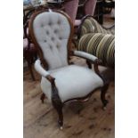 Victorian mahogany framed open armchair in light buttoned fabric.