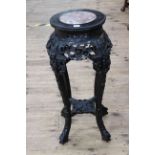 Oriental hardwood and marble inset jardiniere stand, 29cm diameter by 71cm.