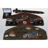 Two military caps and various badges, dagger and enamelled silver Georgian crown brooch.