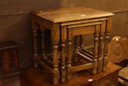 Oak nest of three turned leg tables.