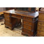 Reproduction mahogany inverted breakfront partners desk having six frieze drawers and drawers and