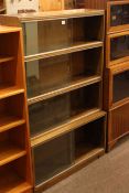 Oak four height sliding glazed door stacking bookcase, 89cm by 140cm.