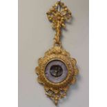 Ornate gilt cased aneroid barometer, length 54cm.